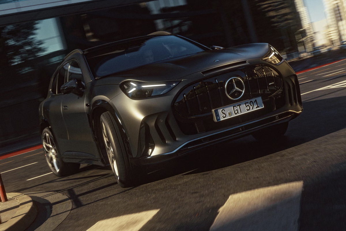 Frontansicht eines grauen Mercedes AMG GT SUV bei dynamischer Fahrt mit markantem Kuehlergrill LED Scheinwerfern und sportlichem Design in urbaner Umgebung
